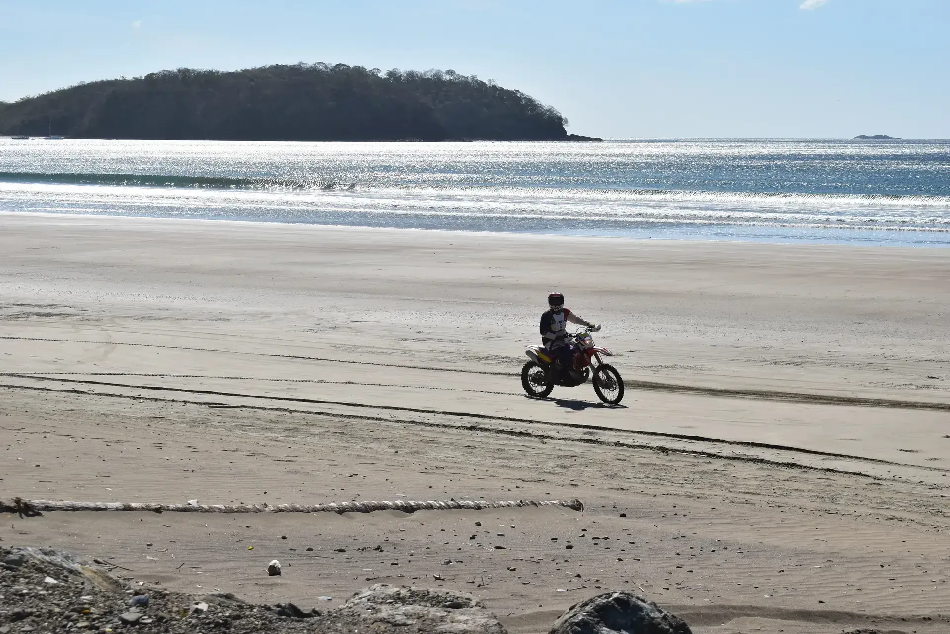 A motorcycle rider in panama riding down a steep hill.