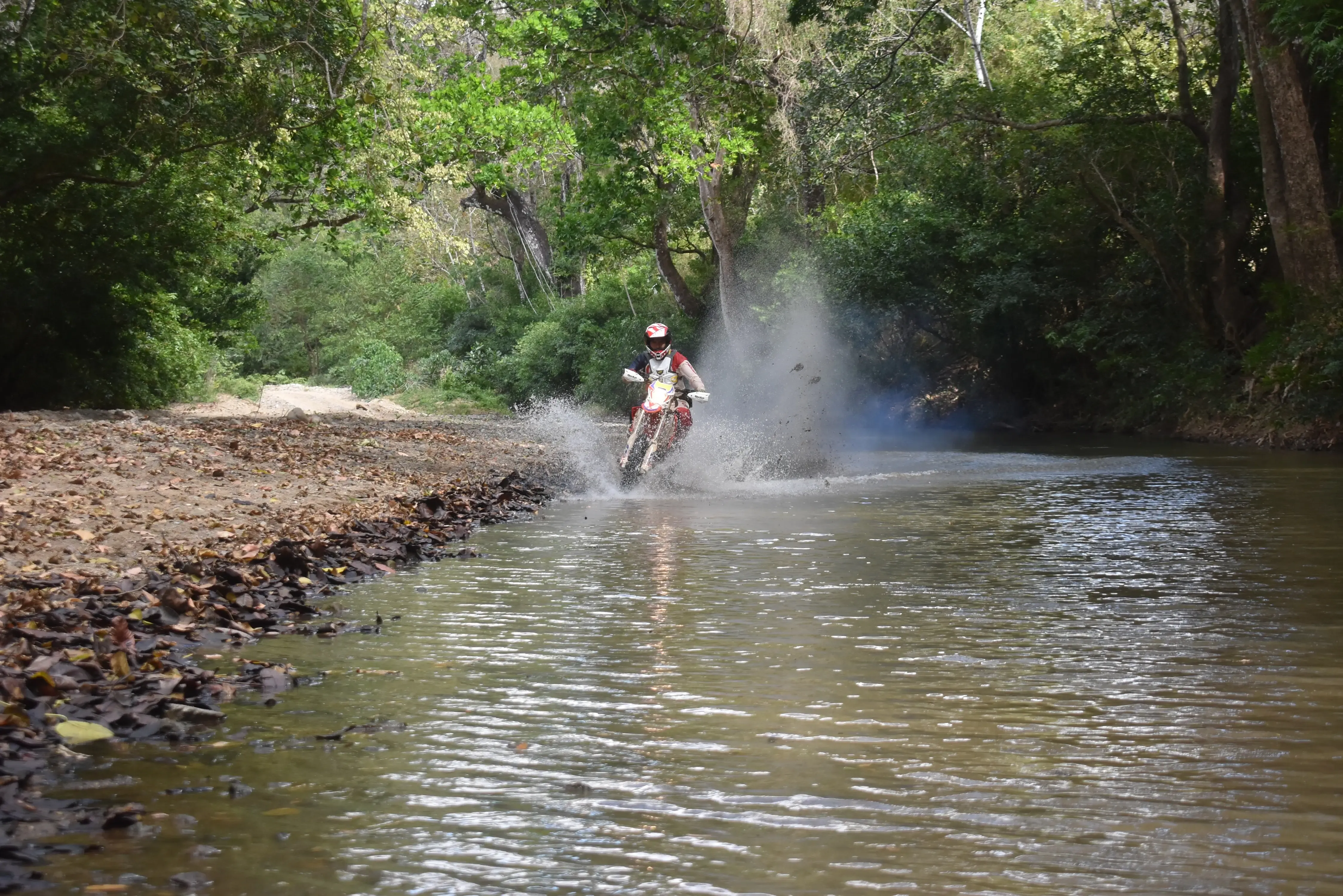 A motorcycle rider in panama riding down a steep hill.