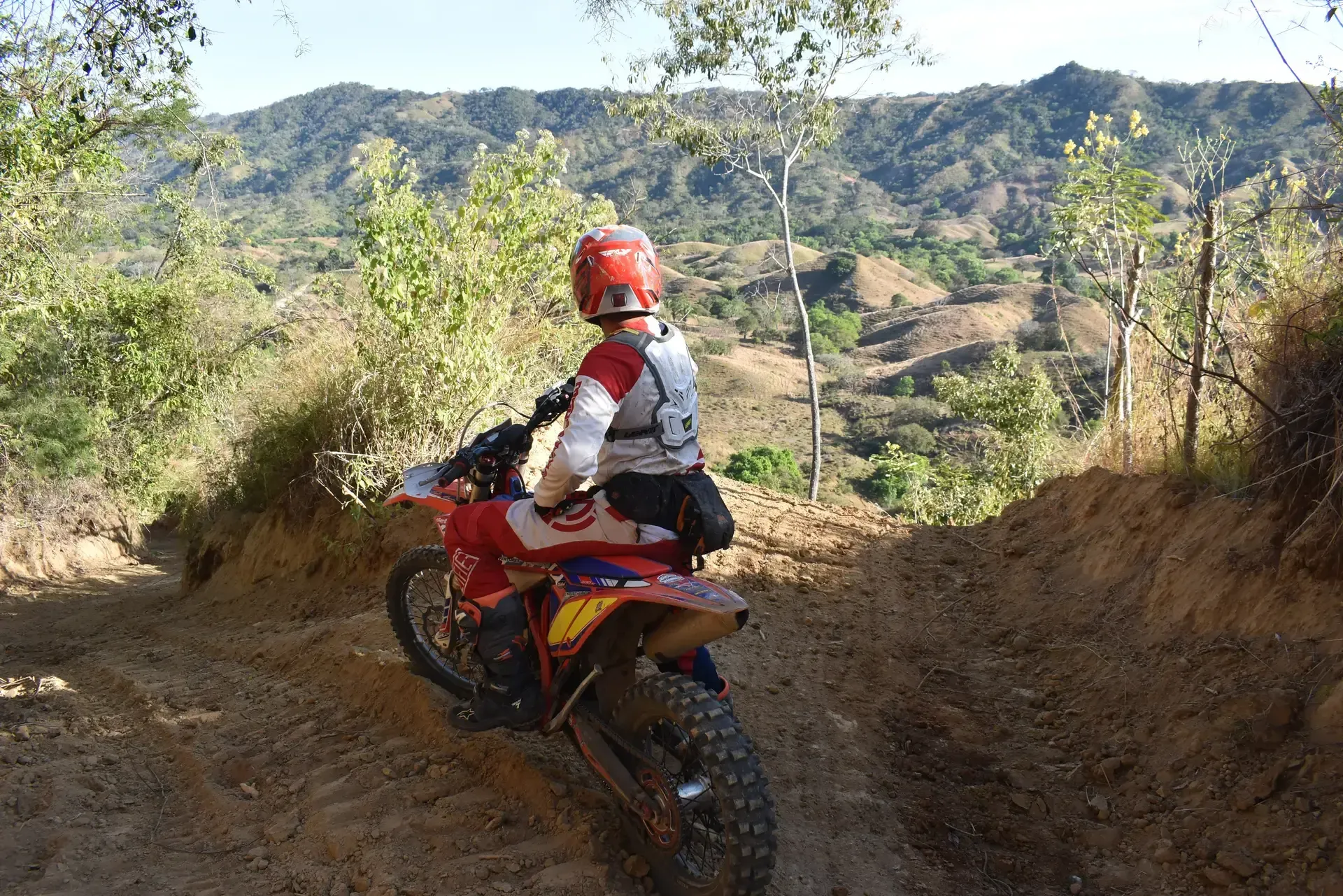 A motorcycle rider in panama riding down a steep hill.